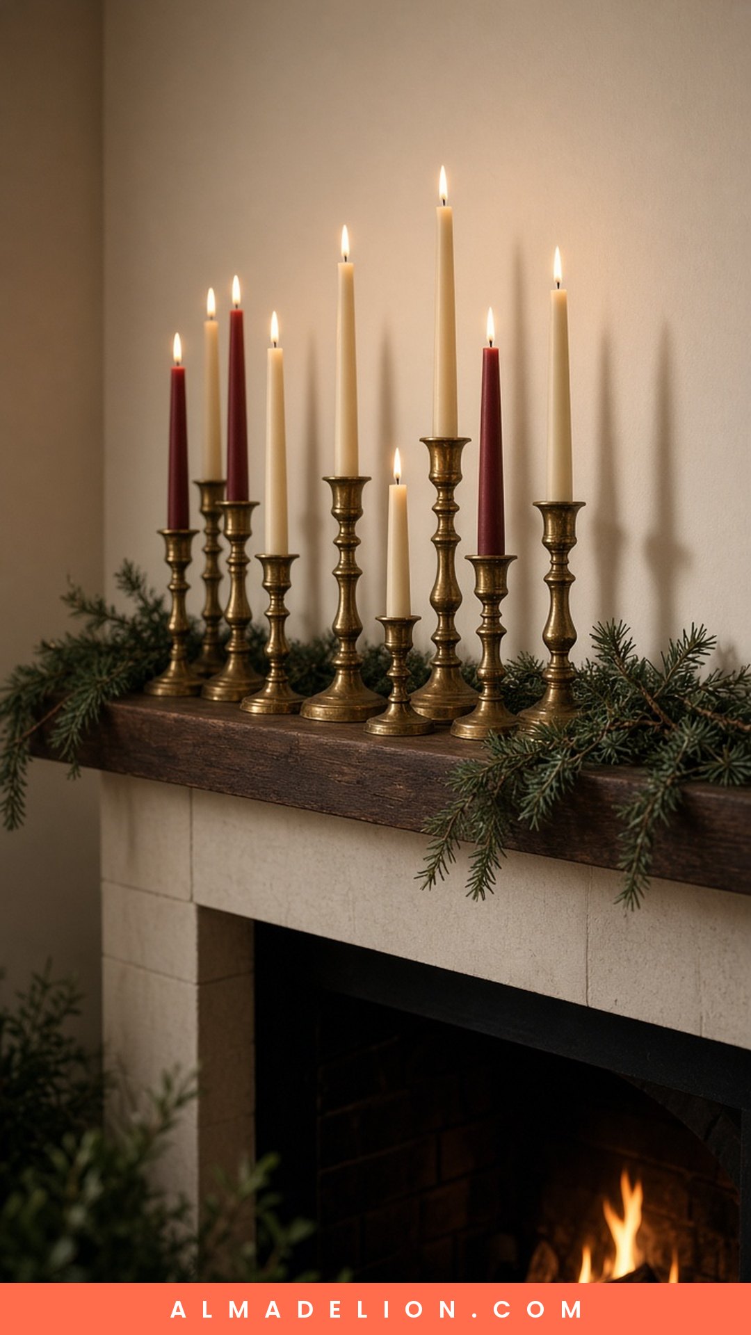 Cluster of vintage brass candlesticks with ivory taper candles on a Christmas mantel