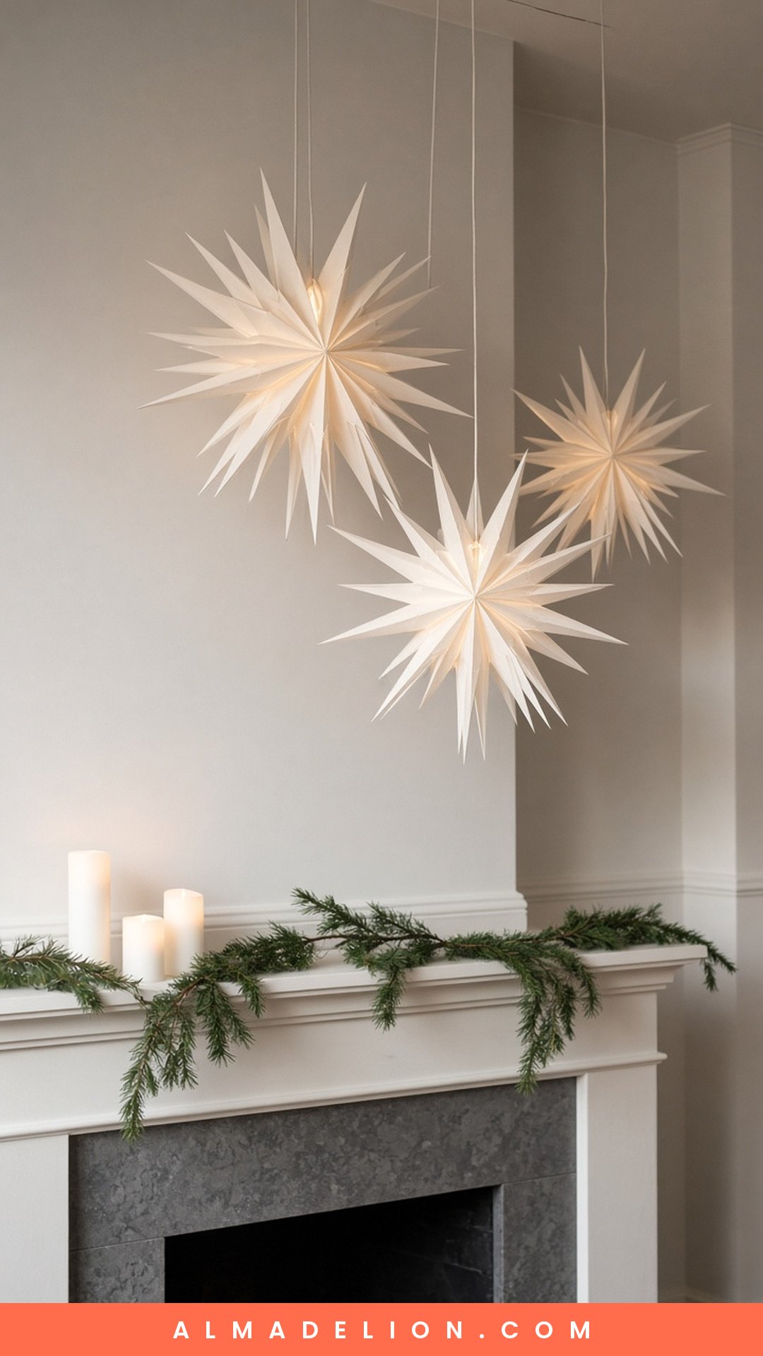 Layered white Scandi paper star lanterns glowing above a minimalist Christmas mantel